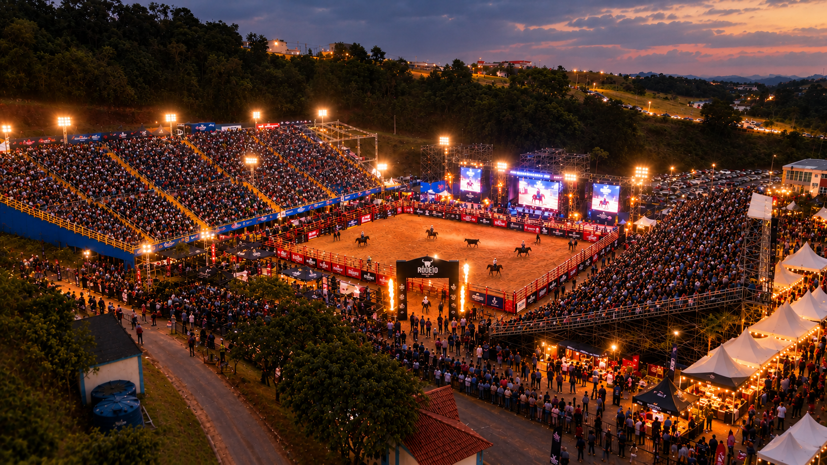 Vista aérea de uma arena de rodeio ao entardecer